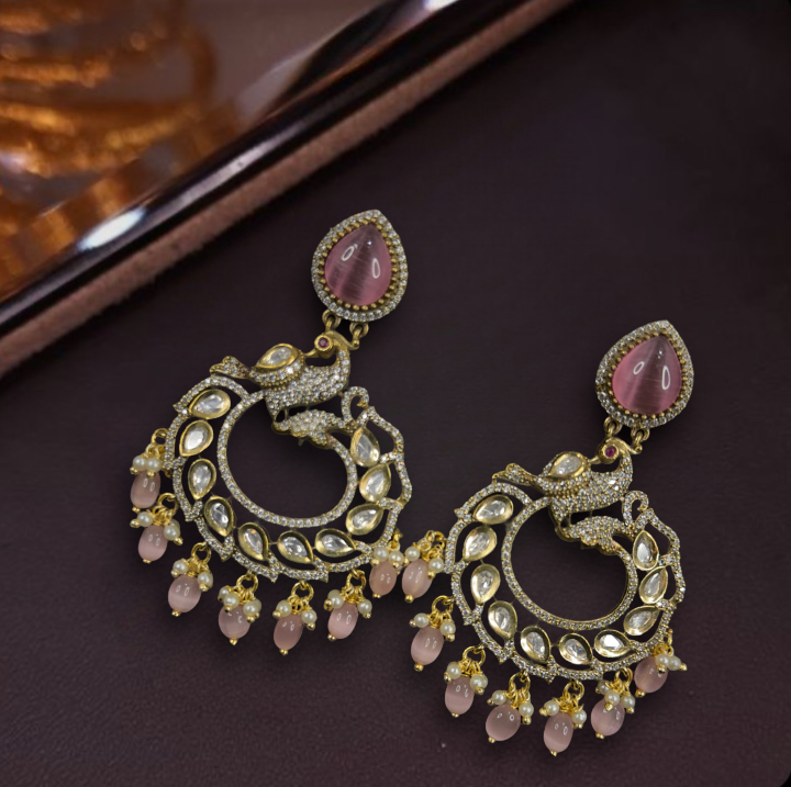  Alluring Victorian Polki Chandbalis Earrings with peacock motif. This Victorian Jewellery is available in a pink colour variant. 