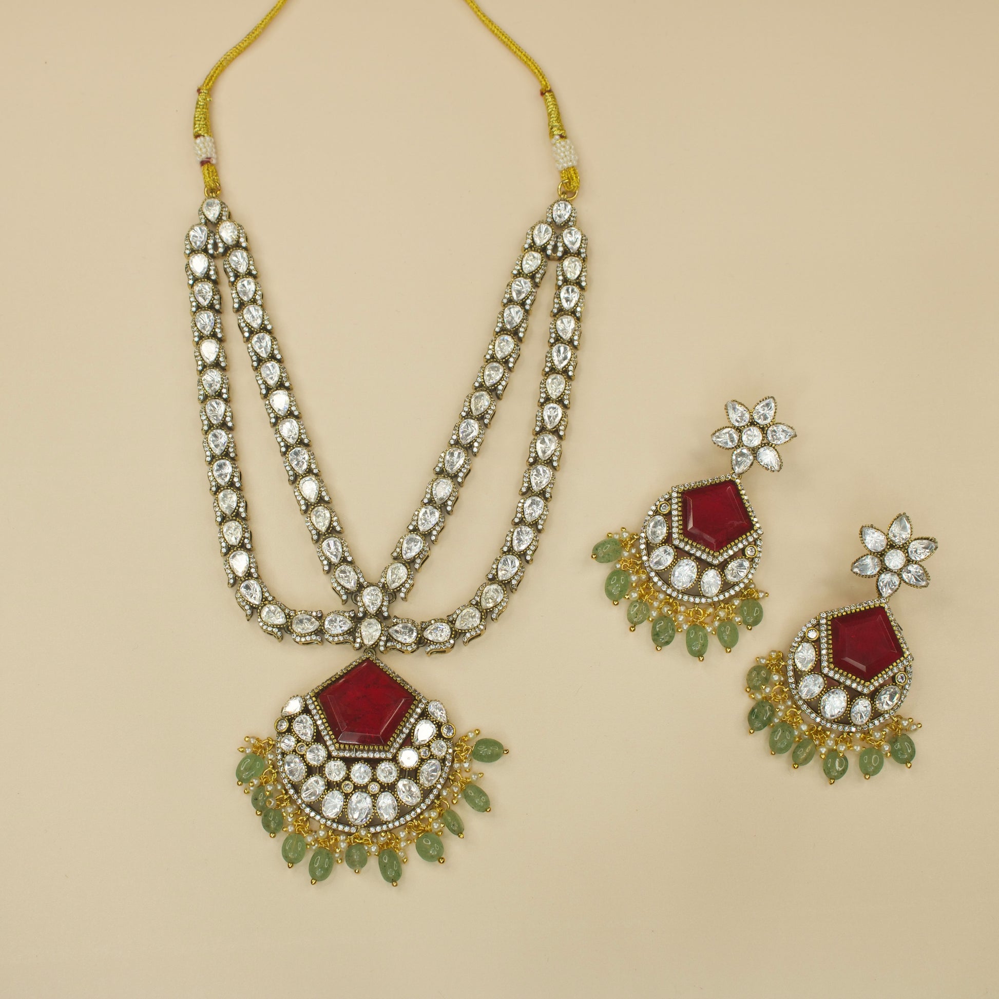 Alluring Two-Line Victorian Necklace Set with zircon, polki, and pearls, and beads, including matching earrings. This Victorian Jewellery is available in Red,Green & Purple colour variants. 