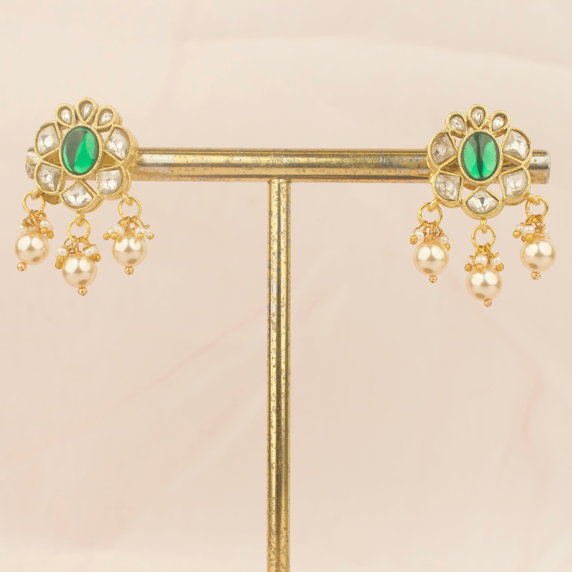 pair of jadau kundan nantad earrings with green center stones and pearl drops