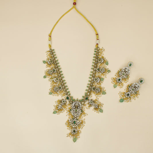 Divine Victorian Necklace Set with zircon, god motif, pearls, and beads, including matching earrings. This Victorian Jewellery is available in Red and Green colour variants. 