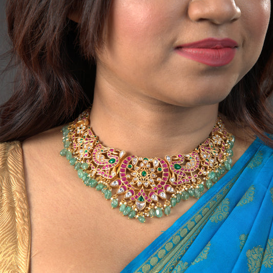 Regal Harmony: Jadau Kundan Necklace with Emerald Flourish with 22k gold plating This product belongs to Jadau Kundan jewellery Category
