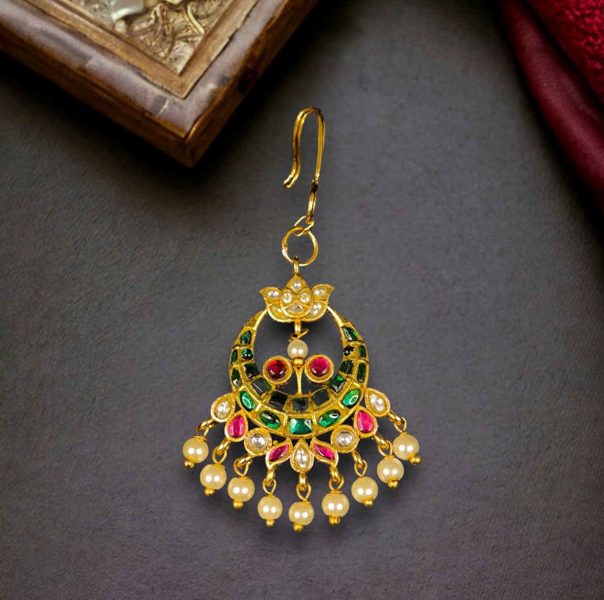 Traditional Crescent Jadau Kundan Maang Tikka with Pearls and Green Accents with 22k gold plating This product belongs to Jadau Kundan jewellery category