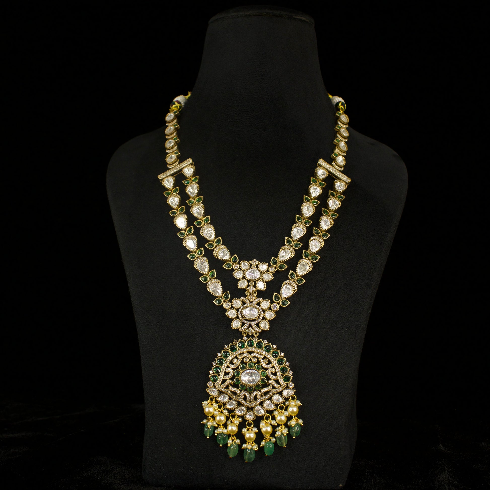 Two-Step Diamond Victorian Necklace Set with zircon, moissanite polki stones, pearls, and beads, including matching earrings. This Victorian Jewellery is available in Red & Green colour variants. 