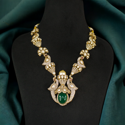 Peacock Victorian Necklace Set with oval-cut green & pink stones, zircon, moissanite polki stones, peacock motif, pearls, and beads, including matching earrings. This Victorian Jewellery is available in Green & Pink colour variants. 