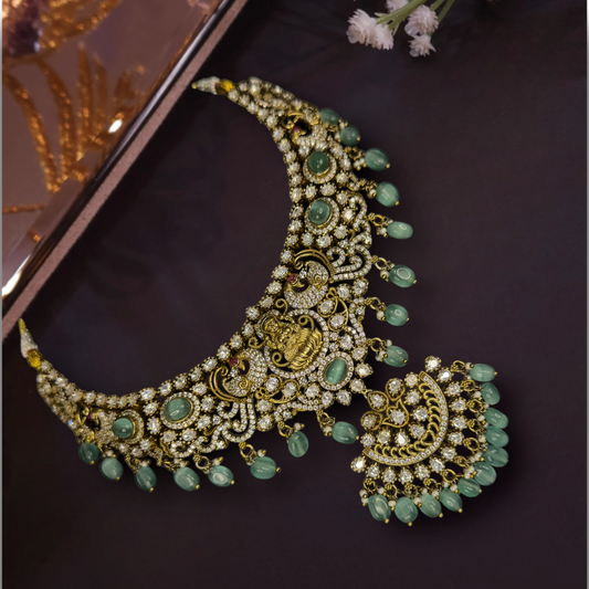 Divine Victorian Necklace Set with Laxmi Devi motif, zircon, moissanite polki stones, pearls, and beads, including matching earrings. This Victorian Jewellery is available in Mint,Green & Purple colour variants. 