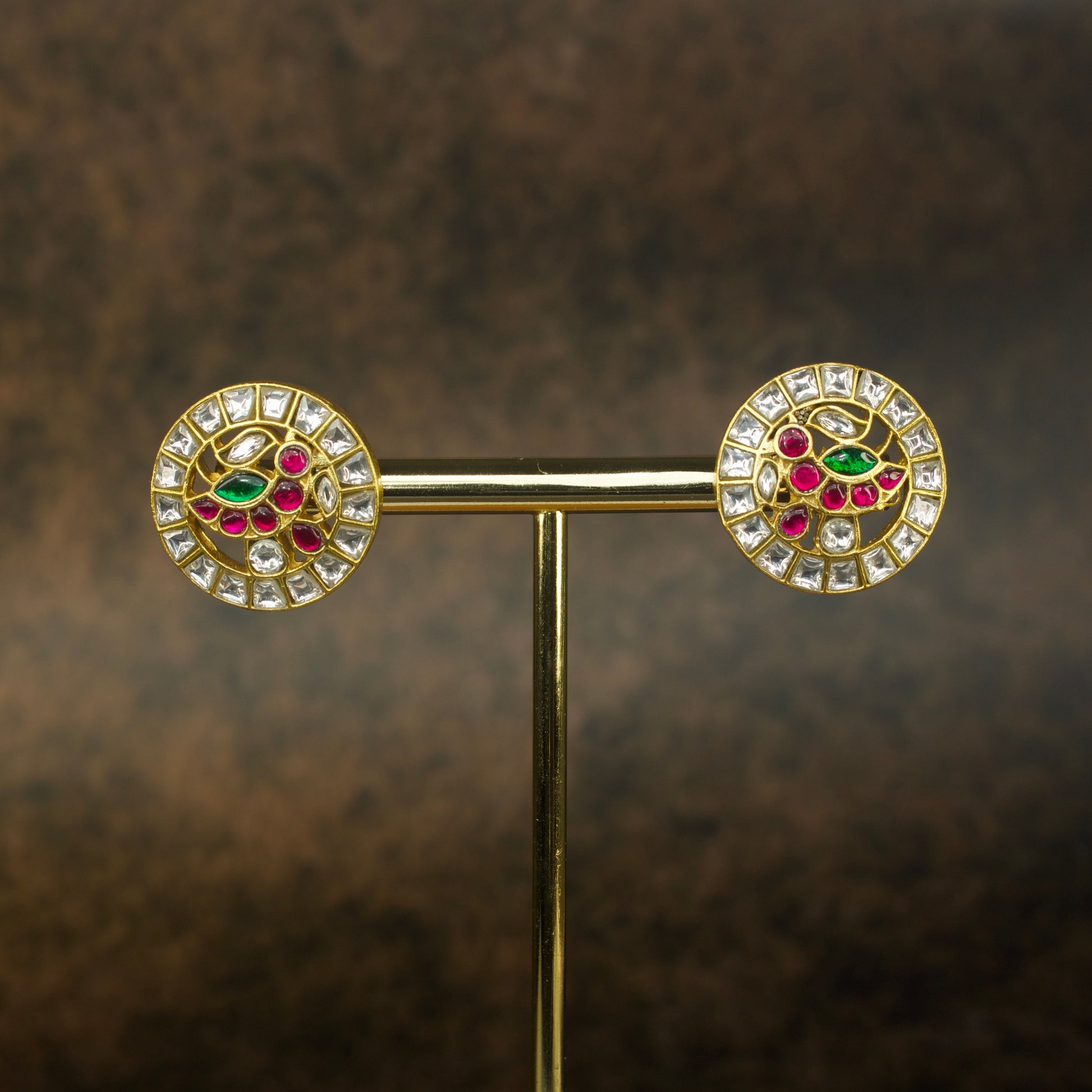 Exquisite Jadau Kundan Coin Studs with handcrafted peacock motif and kundan gemstones.