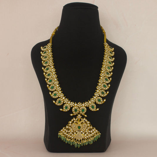 This is a Jadau Kundan Mango Necklace with pendant . This piece has white Kundan stones and is covered in 22k Gold Plating.