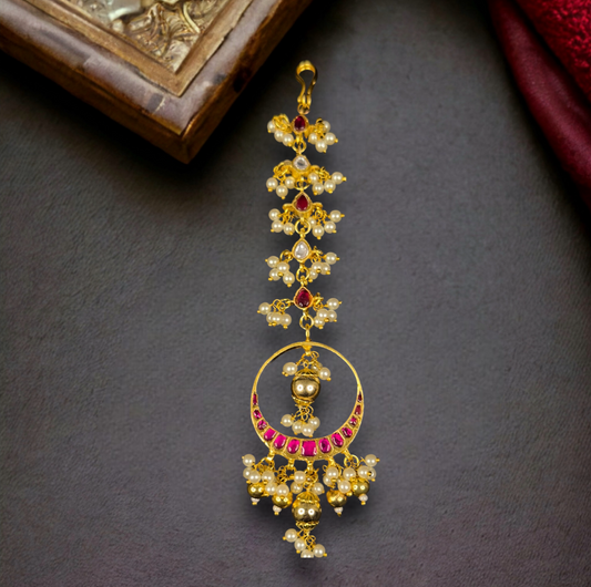Jadau Kundan Chandbali Maangtika with golden beads and pearls in 22k gold plating. this product comes under jadau kundan collection